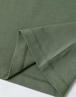 A green premium cotton short sleeve tee shirt, featuring neatly stitched hems and a soft fabric texture.