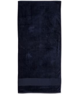A dark navy terry velour beach towel measuring 75x150 cm, featuring a simple design and a branded logo.
