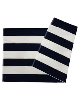 A striped beach towel featuring navy blue and white stripes, with a logo in one corner.