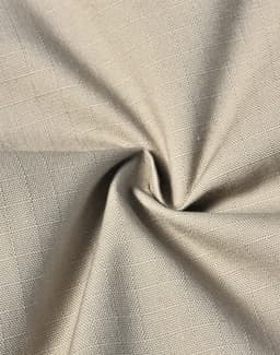 A close-up of rip-stop fabric in a light beige colour, featuring a textured weave. The image displays the fabric's flexibility.