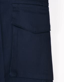 A close-up of navy work shorts featuring a pocket and a logo. The fabric appears durable and stretchy.