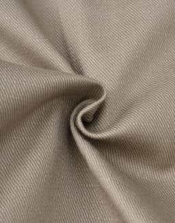 A close-up of beige cotton stretch ripstop fabric, showcasing its smooth texture and woven pattern.