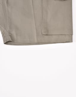 A pair of unisex cotton stretch ripstop work shorts in a light khaki colour, featuring a pocket and stitching details.