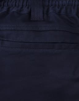 A close-up of navy unisex cotton stretch drill work shorts, featuring an elastic waistband and stitching details.
