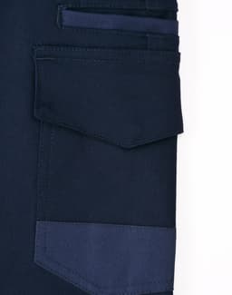 A close-up of navy unisex cotton stretch drill work shorts, featuring multiple pockets and a sturdy design.