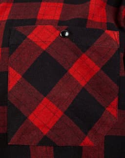 A close-up of a unisex flannel plaid shirt featuring a black and red pattern with a chest pocket.