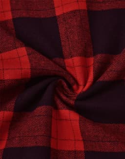 A close-up of a unisex flannel plaid shirt featuring a red and black pattern with a soft texture.
