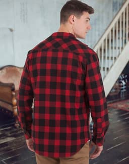A red and black plaid unisex flannel button-up shirt displayed from the back, featuring long sleeves and a logo.