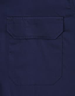 A navy long-sleeve work shirt featuring a closed front and a pocket on the back. The shirt has a branding logo.