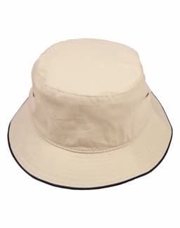 A beige bucket hat featuring a contrast black trim and a small logo on the side.