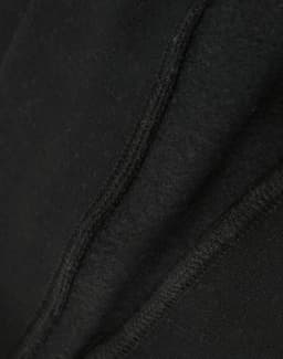 A close-up view of a black crew fleece sweat, highlighting its textured fabric and stitching details.