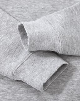 A grey crew fleece sweater featuring long sleeve cuffs and a soft texture, with a logo present.