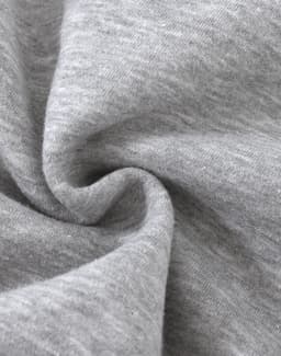 A close-up of soft, grey fabric with a slight texture, typical of a fleece jumper. It features a logo.