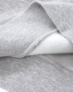A close-up of a grey crew fleece sweatshirt showing the soft interior fabric and detailed stitching.