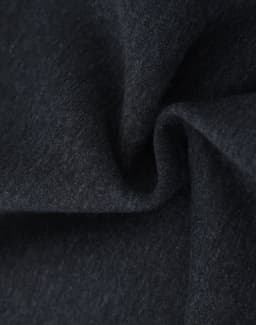 A close-up of dark grey fabric, showcasing a soft and textured fleece material suitable for jumpers.