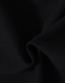 A close-up of black fabric, showcasing a soft, fleecy texture. The material is ideal for apparel like hoodies.