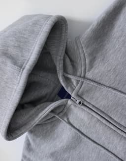 A grey men's full-zip fleecy hoodie with a hood and zippered front. It features a branding logo.