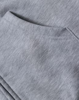 A light grey men's full-zip fleecy hoodie with a front pocket and soft, textured fabric. Features branding.