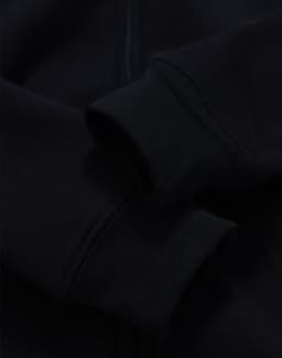 A black kid's full-zip fleecy hoodie featuring cuffed sleeves and a smooth texture. It has a logo on it.