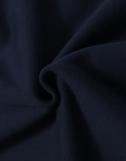 A close-up of soft navy fabric, showcasing the texture and quality of the material.