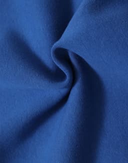 A swirling piece of blue fleece fabric, showcasing its soft texture and warm quality.