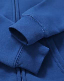A blue full-zip fleecy hoodie featuring a logo and ribbed cuffs.
