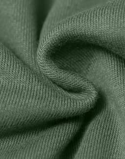 A close-up of textured fabric in a muted green colour, highlighting its soft and snug qualities.