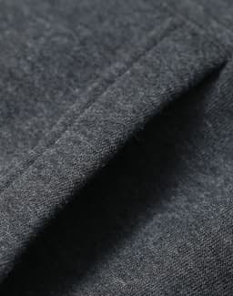 A close-up of a fleecy fabric in dark grey, showcasing the texture of the adult's contrast front hoodie.