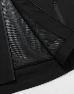 A black unisex waterproof jacket featuring a mesh lining along the inside for breathability. It has a logo.