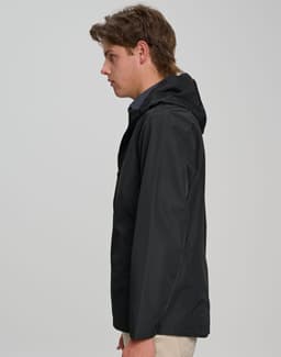 A black unisex waterproof jacket with a hood and a side view of a model wearing it. Features a logo on the jacket.