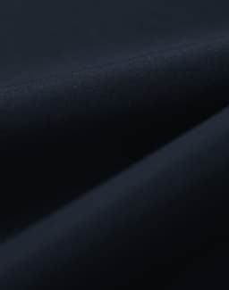 A close-up of a dark navy fabric, featuring a smooth texture suitable for a waterproof jacket.