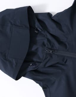 A unisex pro performance waterproof jacket in navy blue, featuring a hood and zip closure. It has a logo on the fabric.