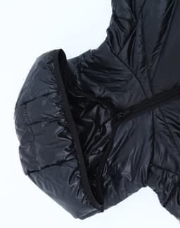 A black lightweight hooded puffer jacket with a zipper and a structured hood. The material appears smooth and glossy.