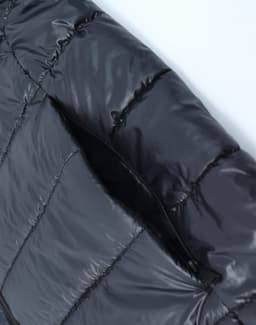 A black lightweight hooded puffer jacket featuring stitched details and an open zip pocket.