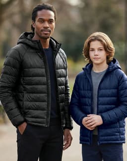 Two models wearing lightweight puffer jackets; one in black and the other in navy blue, both with hoods.