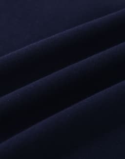 A close-up of navy cotton fabric with visible stretch and texture, ideal for polo shirts.