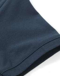 A navy ladies cotton stretch polo shirt featuring a smooth fabric texture and a well-finished hem.