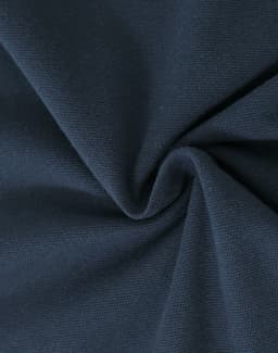 A close-up of navy cotton fabric displaying its soft texture and stretch qualities.