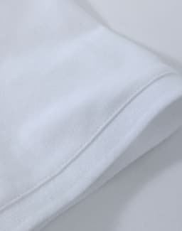 A white ladies cotton stretch polo shirt, featuring a classic collar and short sleeves, with a logo present.