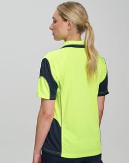 A woman wearing a high-visibility yellow and navy safety polo shirt, featuring a logo on the chest and back.