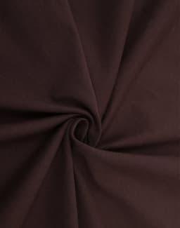 A close-up view of rich brown cotton fabric, showcasing its smooth texture and soft drape.