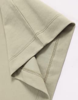 A close-up of a light green premium cotton short-sleeve tee shirt with a stitched hem and sleeve detail.