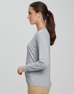 A long-sleeve, grey ladies' premium cotton tee shirt presented on a model in profile. The shirt features a subtle logo.
