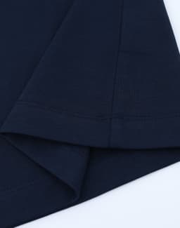A navy blue long-sleeve cotton tee shirt featuring a hemmed finish and a logo on the sleeve.