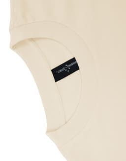 A beige unisex heavy cotton oversized tee featuring a label on the sleeve.