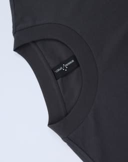 A dark grey unisex oversized cotton tee featuring a round neckline and a tag on the inside.