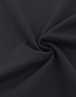A close-up of a black heavy cotton fabric, showcasing its soft texture and smooth surface.