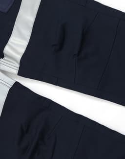 Cotton stretch drill cuffed work pants in navy with reflective tape detail, featuring a logo.