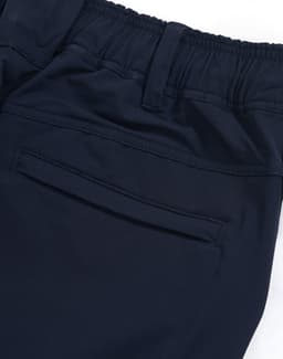 Navy blue flexi work pants featuring an elastic waistband and a rear pocket. Includes branding on the fabric.