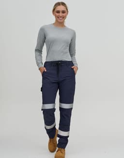 Navy water-repellent flexi work pants with reflective tape, worn by a person in a grey long-sleeve top.